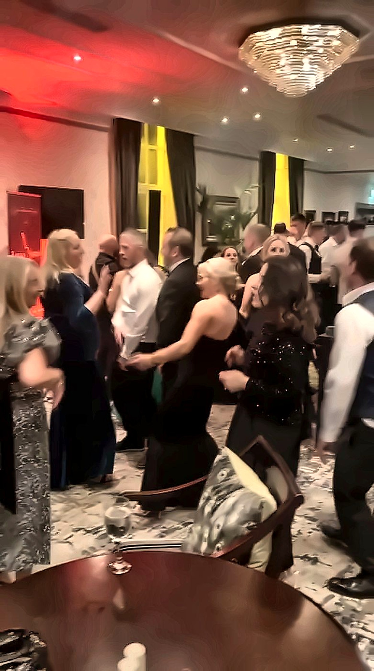 A full ballroom of guests dancing